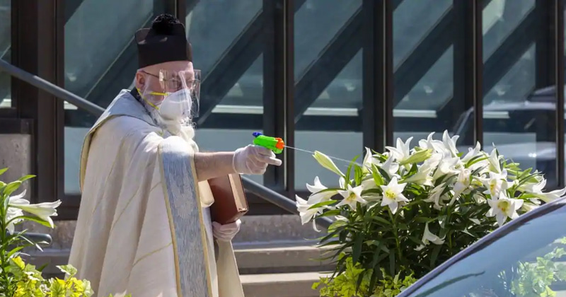 us priest sprays holy water from toy gun