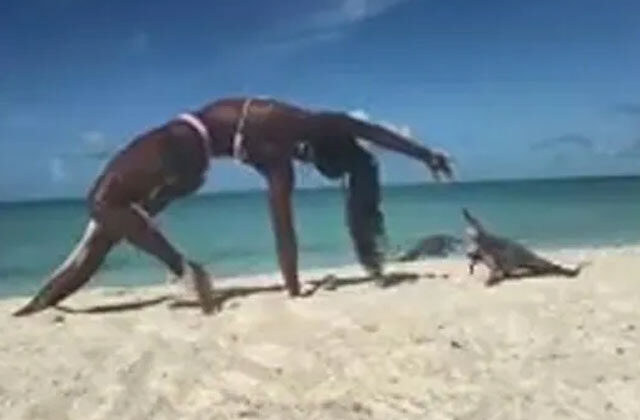 Woman Doing Yoga on Beach